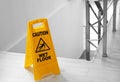 Safety sign with phrase Caution wet floor near stairs Royalty Free Stock Photo