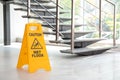 Safety sign with phrase Caution wet floor near stairs Royalty Free Stock Photo