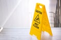 Safety sign with phrase Caution wet floor near stairs Royalty Free Stock Photo