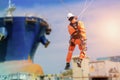 Worker sprinkle from height in shipyard.