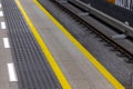 Yellow warning lines on a subway or train station platform. Royalty Free Stock Photo