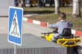 Safety traffic playground. Driving school kids education road rules. Small boy driving toy car on playground child learn traffic Royalty Free Stock Photo