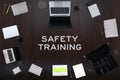 Safety training concept. Top layout of drawings of laptops, notepads, coffee, different business stuff on table background