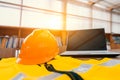 Safety work at Industrial and Factory concept. Engineer Construction Safety hat helmet on office working desk with laptop Royalty Free Stock Photo