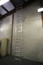 Safety workplace industrial Aluminium safety ladder installed on the vertical interior concrete wall