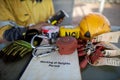 Safety workplace working at heights permit book on the table defocused an inertia reel shock absorbing fall protection device Royalty Free Stock Photo