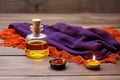 a saffron cloth, mala beads, and a brass diya oil lamp on a wooden board