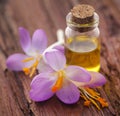 Saffron crocus flower with extract in a bottle Royalty Free Stock Photo