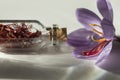 Saffron flower and dried saffron spice in a bottle Royalty Free Stock Photo
