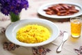 saffron flowers next to a finished plate of risotto milanese