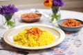 saffron flowers next to a finished plate of risotto milanese Royalty Free Stock Photo