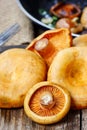 Saffron milk cap mushrooms on wooden table Royalty Free Stock Photo