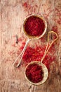 Saffron spice in rustic sieve on old wooden background