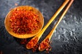 Saffron Spice. Saffron spices on black stone table in a wood bowl and a spoon. Spice and herbs on slate background. Seasonings Royalty Free Stock Photo