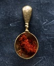 Saffron Spice. Saffron spices in a brass spoon. Indian spice top view. Seasonings, condiments.