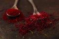 Saffron spice threads and powder in vintage old spoons Royalty Free Stock Photo