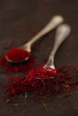 Saffron spice threads and powder in vintage old spoons Royalty Free Stock Photo