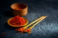 Saffron spices. Saffron on black stone table in a wood bowl and a spoon Royalty Free Stock Photo