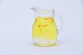 Saffron tea from red stamens in a transparent jug on a white background. Royalty Free Stock Photo
