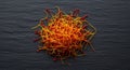 Saffron threads on a dark slate background create a vibrant and flavorful spice display Royalty Free Stock Photo