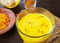 Saffron turmeric golden milk in glass mug