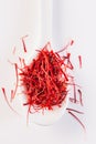 Saffron in white spoon on white background Royalty Free Stock Photo