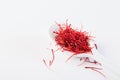 Saffron in white spoon on white background Royalty Free Stock Photo