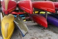 Kayaks and canoes close up stored in racks upside down in front view.