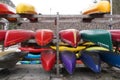 Kayaks and canoes stored in racks upside down in front view.