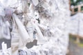 Saga, Japan - Nov. 12, 2018: Japanese random fortune telling paper Omikuji folded and tied on rope wires Omikuji kake in