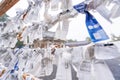 Saga, Japan - Nov. 12, 2018: Japanese random fortune telling paper Omikuji folded and tied on rope wires Omikuji kake in