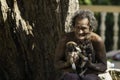 Sagaing/Myanmar-October 3rd 2019: A Burmese old man is carrying two puppies with love