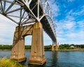 Sagamore bridge spans Cape Cod Canal under a sky dominated by Cirrus clouds