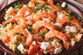 Saganaki prawns with feta cheese and tomatoes close-up. horizontal Royalty Free Stock Photo