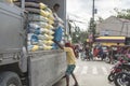 Sagbayan, Bohol, Philippines - A porter unloads sacks of rice from a truck to the local market