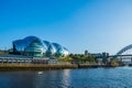 The Sage Gateshead, Tyne Bridge and river Tyne. The Sage Gateshead is an international  home for music located on the south bank Royalty Free Stock Photo