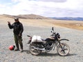 SAGSAY, MONGOLIA - MAY 22, 2012: Portrait native of Mongolian man who carry meal on his motorcycle to home in desert mountain