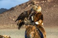 Berkutchi Eagle Hunter with golden eagle during hare hunting.