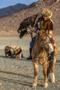 Berkutchi Eagle Hunter with golden eagle during hare hunting.