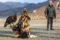 Berkutchi Eagle Hunter while hunting to the hare with a golden eagles on his arms