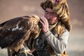 Berkutchi - Eagle Hunters traditional clothing, while hunting to the hare holding a golden eagles on his arms