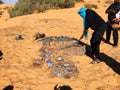 Cooking chicken in Algerian Sahara Desert