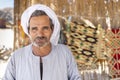 Sahara desert, Egypt - December 22, 2019: Portrait of an old desert bedouin who sells carpets.