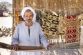 Sahara desert, Egypt - December 22, 2019: Portrait of an old desert bedouin who sells carpets.