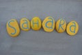 Sahara desert located on the African continent, souvenir with handmade yellow painted stone letters on the sand