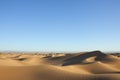 Sahara desert sand dunes with clear blue sky. Royalty Free Stock Photo