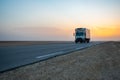 07.11.23 Sahara Desert, Tunisia: Beautiful colourful sunset over endless road, car in middle of desert. Asphalt highway in Tunisia