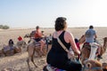 06.11.23 Sahara, Tunisia: Group of tourist ride on camels at sunset in Sahara Desert Tunisia.