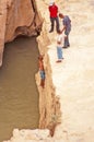 A swimmer climbs up in a narrow gorge in northern Sahara, Tunisia, Northern Africa