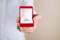 Engagement / marriage / wedding proposal scene. Close up of man handing the expensive gold platinum diamond ring to his bride. Royalty Free Stock Photo